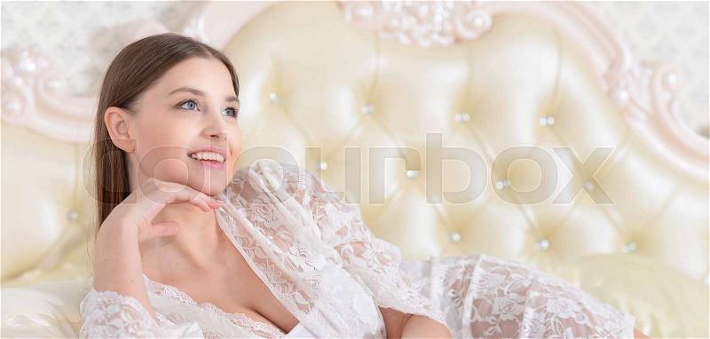 Portrait of a beautiful young girl in bed, stock photo