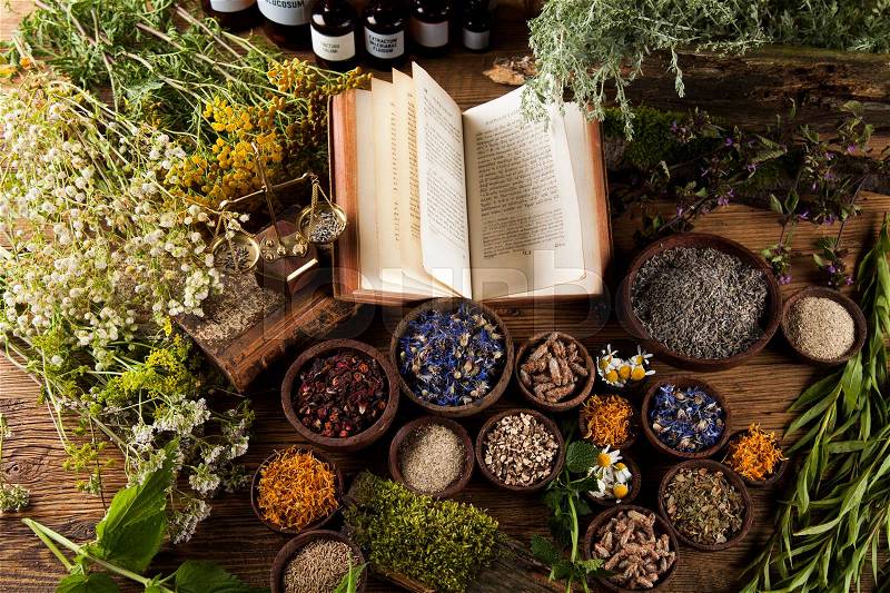 Book and Herbal medicine on wooden table background, stock photo