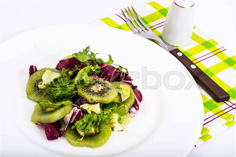 Vegetarian menu- salad of leaf lettuce, kiwi, olive oil, spices, stock photo