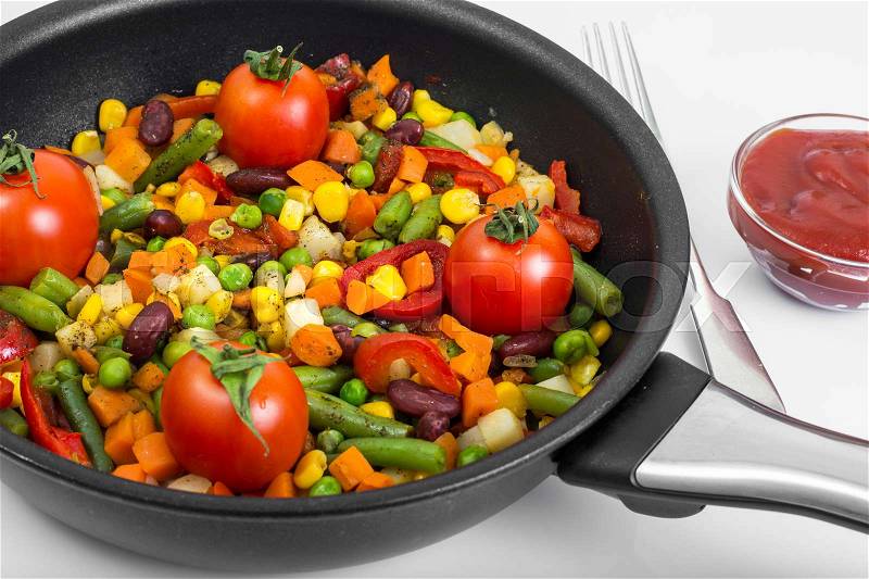 Steamed vegetables with tomatoes in pan. Studio Photo, stock photo