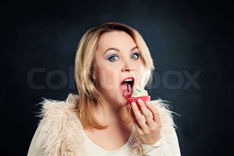 Woman Biting Cake. Model with Unhealthy Food. Overweight Concept, stock photo