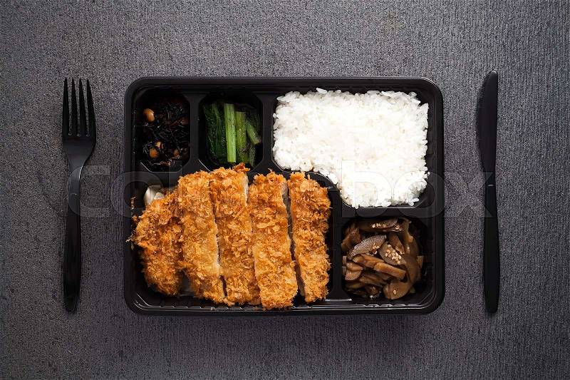 Japanese food tonkatsu rice and vegetable take away on table background flat lay still life tasty meal, stock photo