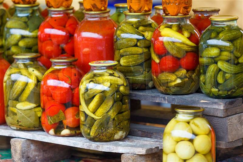 Jars with pickled vegetables. Preserved vegetables. tomatoes and cucumbers. preserved tomatoes and cucumbers at market, stock photo