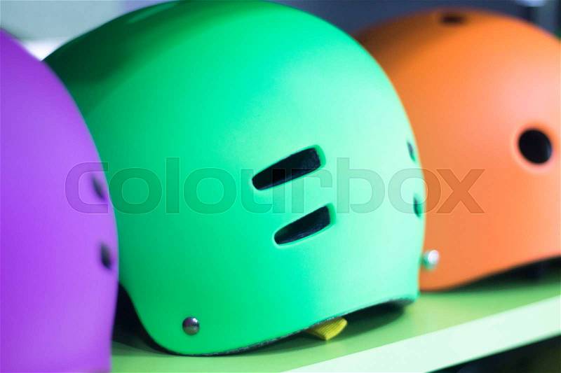 Inline and quad roller skates helmets head protection in retail skate shop display on sale, stock photo