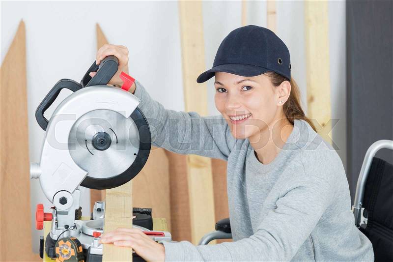 Woman carpenter at work, stock photo