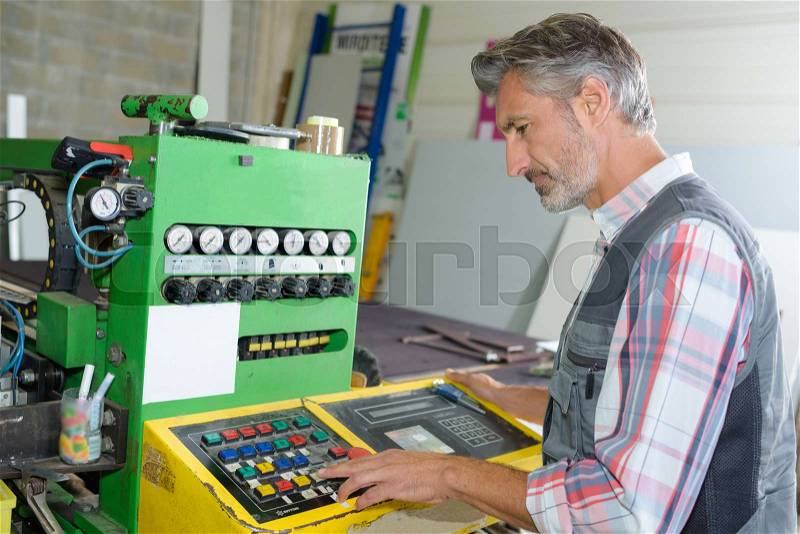 Man programming machine, stock photo