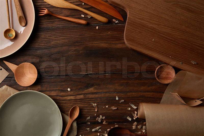 Kitchen devices concept. Plank with baking parchment in kitchen. Composition of kitchen devices represented on wooden table, stock photo