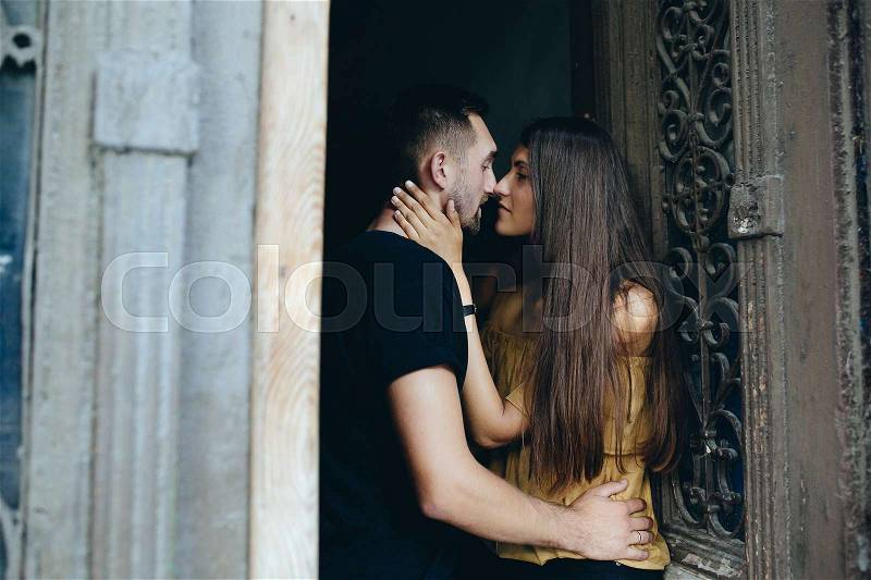 Couple posing in the doorway posing on camera, stock photo