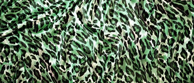 Silk leopard print fabric close up background, stock photo