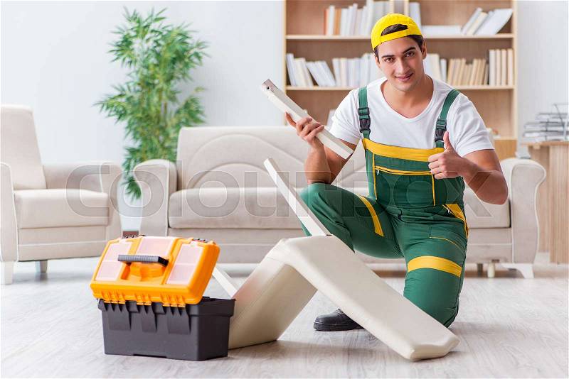 Worker repairing furniture at home, stock photo