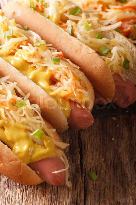 Sandwich with sausage, sauerkraut and mustard close up on the table. vertical , stock photo