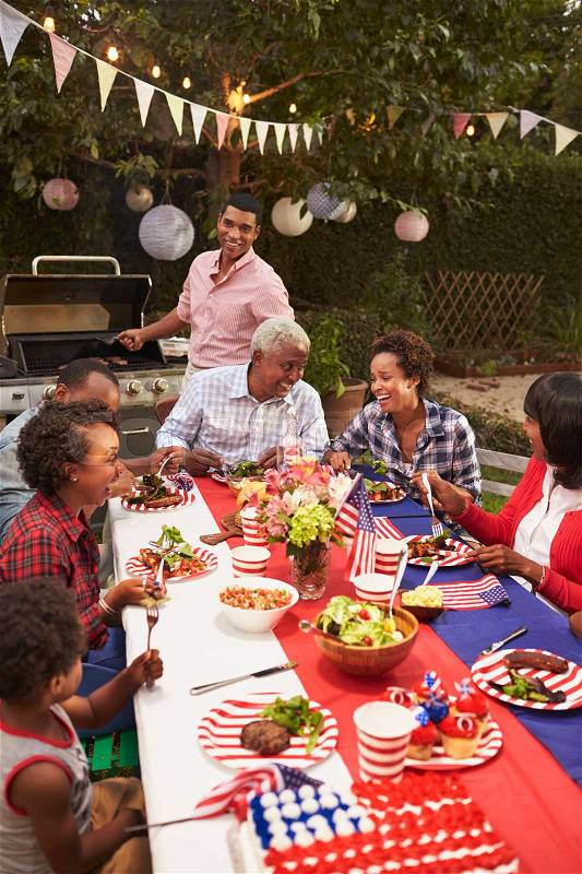 Multi generation black family at 4th July barbecue, vertical, stock photo