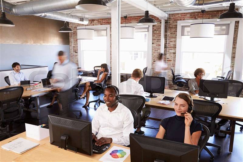 View Of Staff In Busy Customer Service Department, stock photo