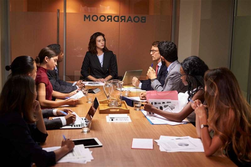 Female boss chairing a business meeting in a boardroom, stock photo