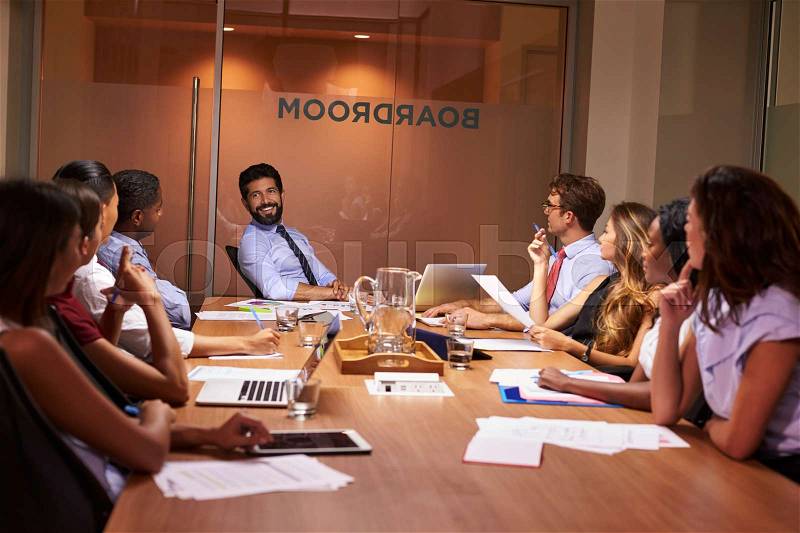 Relaxed moment at an evening corporate business meeting, stock photo