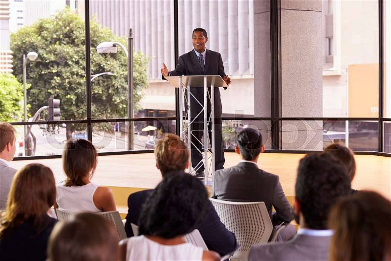 Black businessman presenting business seminar to an audience, stock photo
