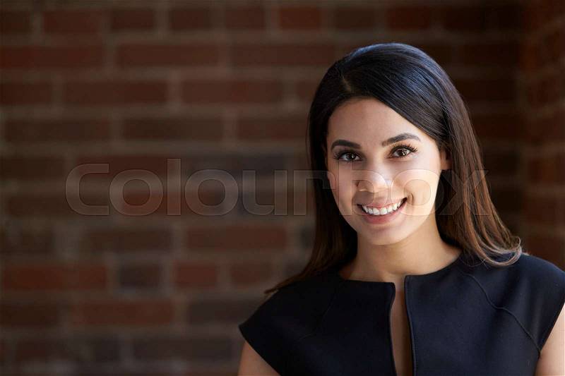 Head And Shoulders Portrait Of Young Businesswoman In Office, stock photo