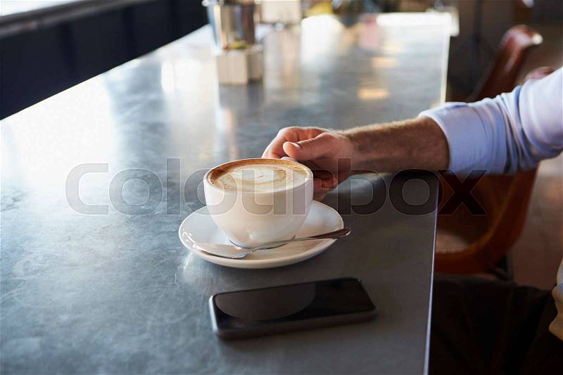 Close Up Of Man With Mobile Phone On Counter Of Coffee Shop, stock photo