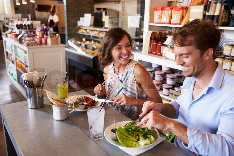 Couple Enjoying Lunch Date In Delicatessen Restaurant, stock photo