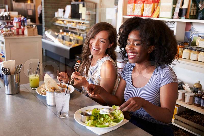 Two Women Enjoying Lunch Date In Delicatessen Restaurant, stock photo