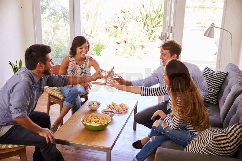 Couple Entertaining Friends At Home, stock photo