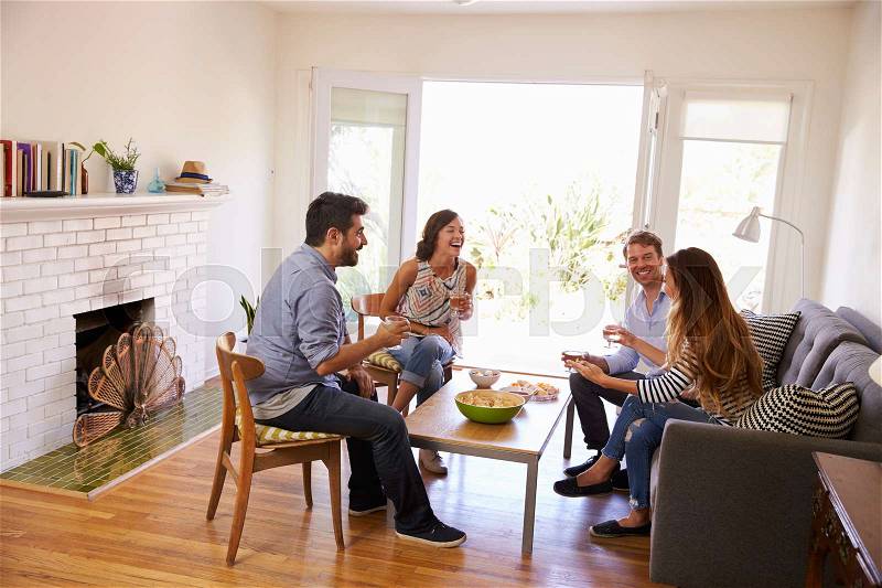 Couple Entertaining Friends At Home, stock photo