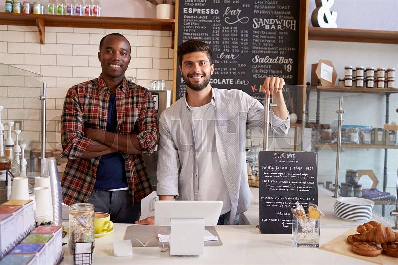 Business partners at the counter of a coffee shop, close up, stock photo