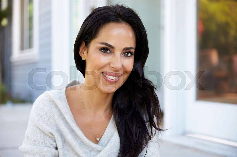 Portrait Of Woman Sitting On Steps Outside Home, stock photo