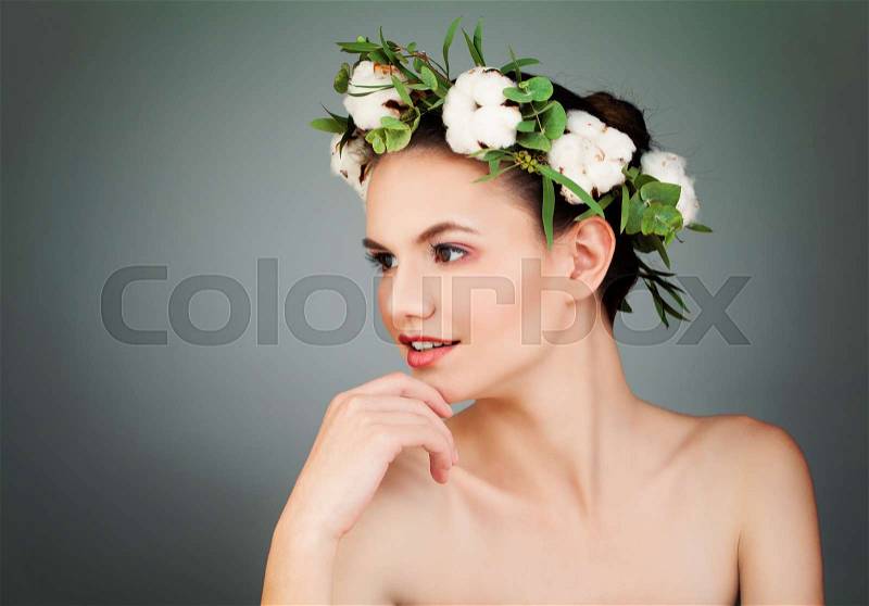 Pretty Woman Wearing Cotton Flowers Wreath on Blue Background, stock photo