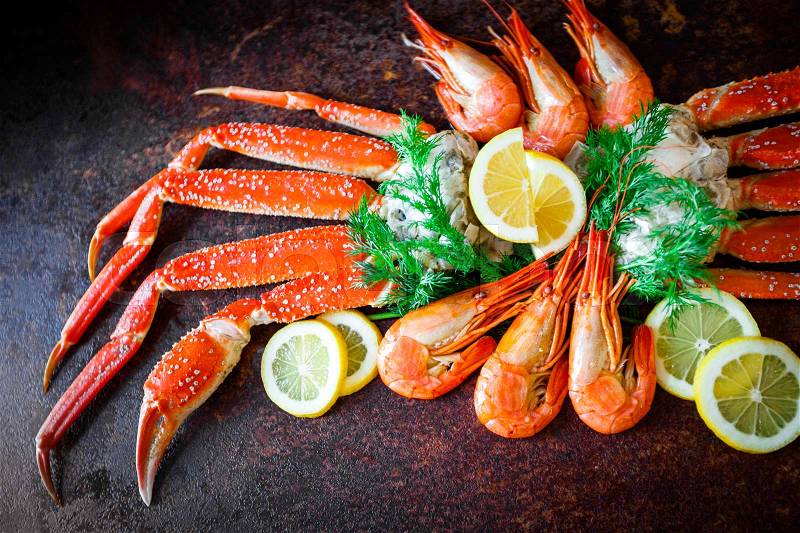 Crab legs with lemon and shrimps, stock photo
