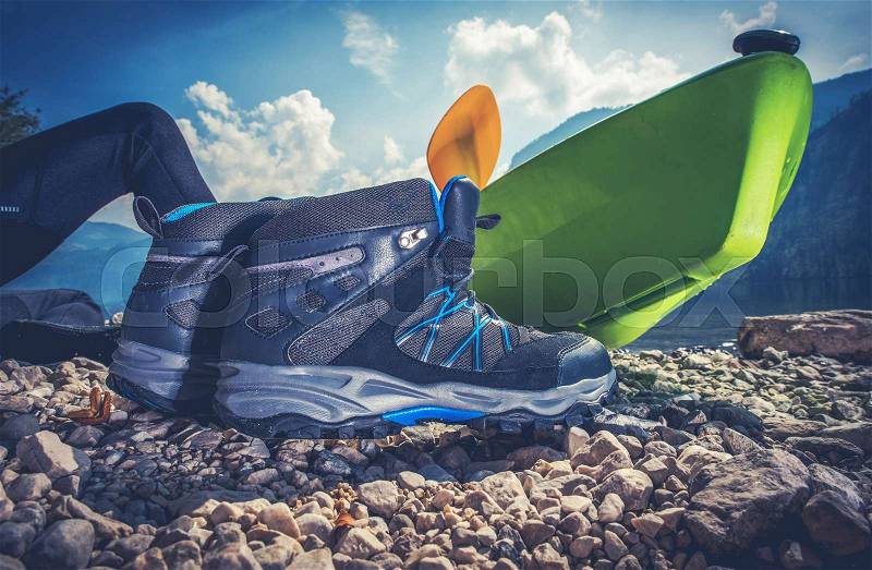 Outdoor Recreation Objects. Good Outdoor Hiking Shoes, Kayak and the Camping on the Edge of the Lake, stock photo