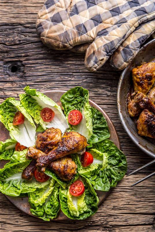 Grilled chicken legs lettuce and cherry tomatoes. Traditional cuisine. Mediterranean cuisine, stock photo