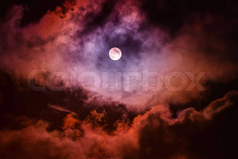 The moon on the dark sky among the clouds, natural abstract background, stock photo