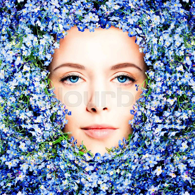 Beautiful Model Woman in Flowers. Female Face closeup, Blossom Beauty, stock photo