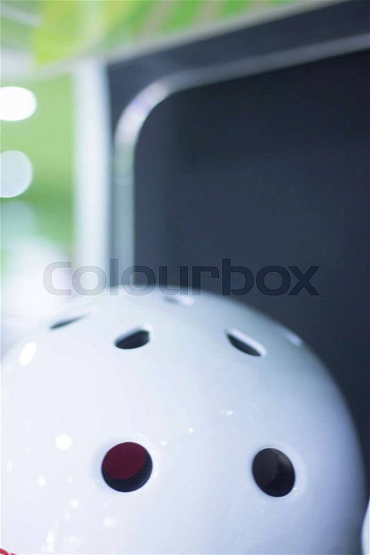 Inline and quad roller skates helmet head protection in retail skate shop display on sale, stock photo