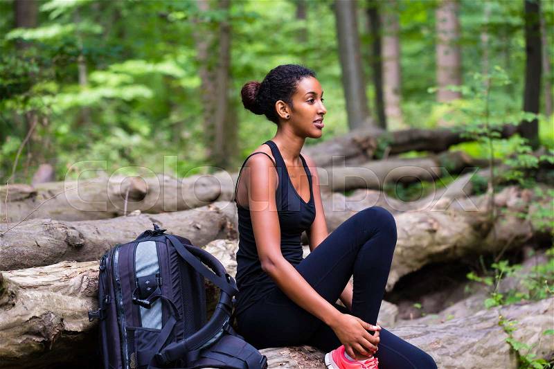 African young woman hiking on forest track , stock photo