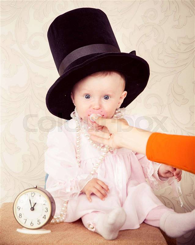 The baby around the clock on a background of ivory, stock photo