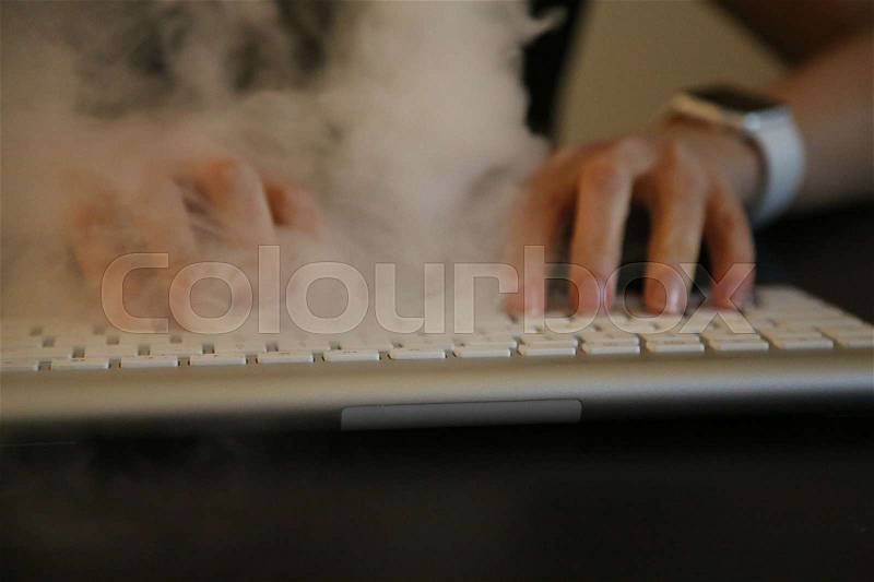 Concept workaholic smoke over keyboard, stock photo