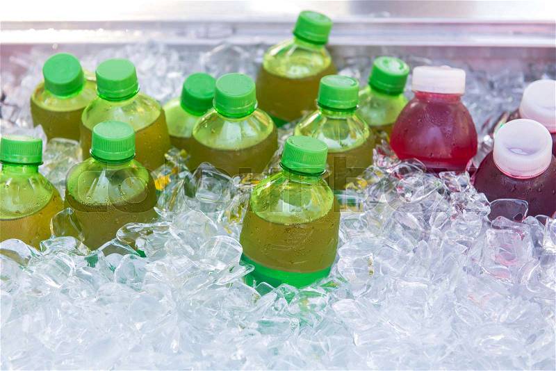 Mixed cold juice bottle in the ice box, stock photo