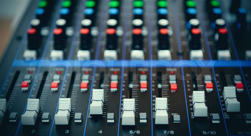 Detail of a music mixer desk with various knobs, stock photo