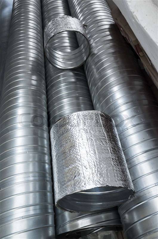 Group of shiny metallic tubes for air ventilation systems, vertical photo, stock photo
