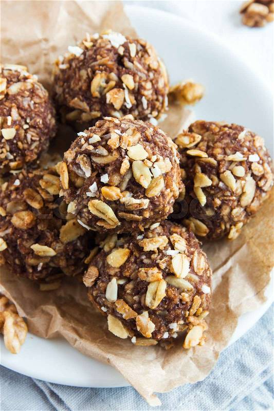 Healthy organic energy granola bites with nuts, cacao, banana and honey - vegan vegetarian raw snack or meal, stock photo