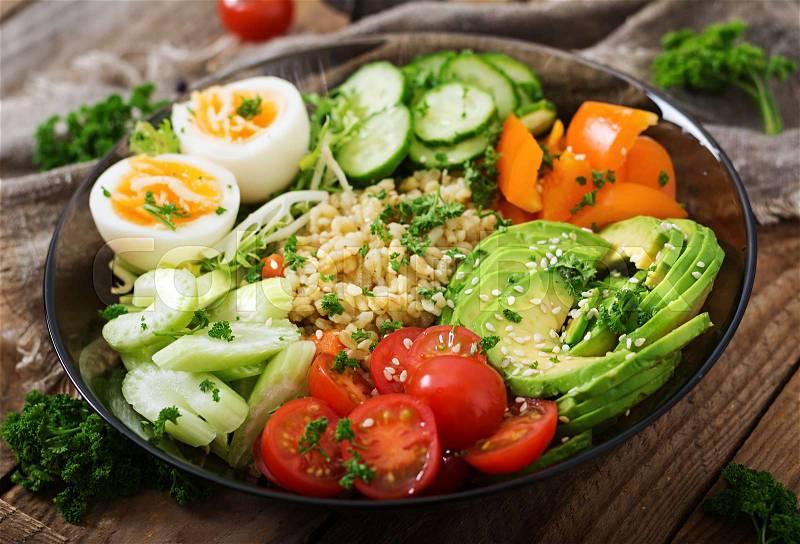 Diet menu. Healthy lifestyle. Bulgur porridge, egg and fresh vegetables - tomatoes, cucumber, celery and avocado on plate, stock photo