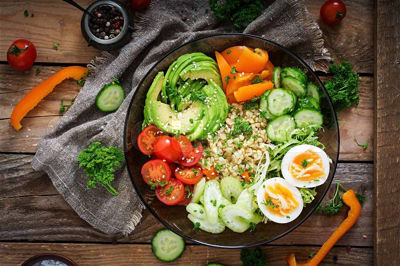 Diet menu. Healthy lifestyle. Bulgur porridge, egg and fresh vegetables - tomatoes, cucumber, celery and avocado on plate. Top view. Flat lay, stock photo