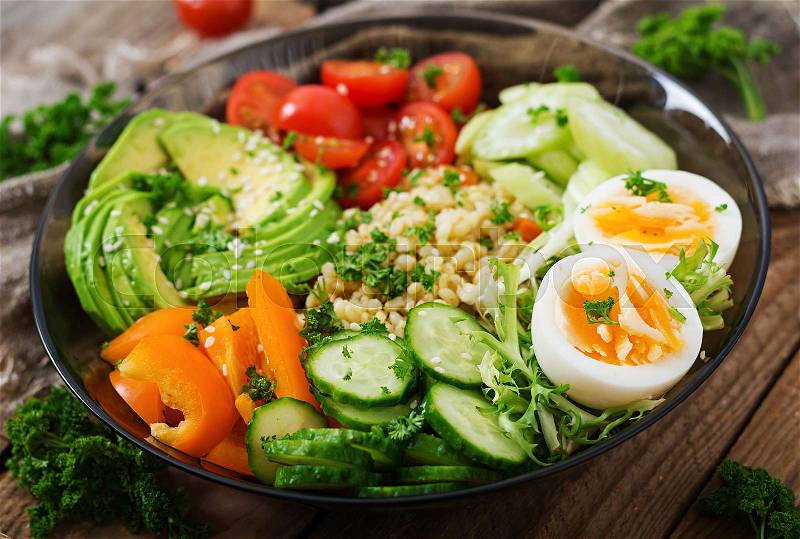 Diet menu. Healthy lifestyle. Bulgur porridge, egg and fresh vegetables - tomatoes, cucumber, celery and avocado on plate, stock photo