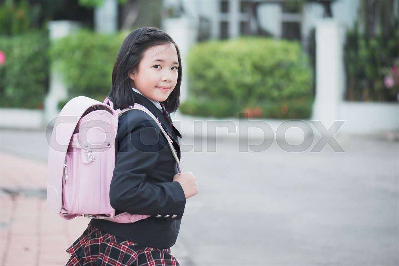 Beautiful Asian school girl with pink backpack outdoors,back to school concept, stock photo