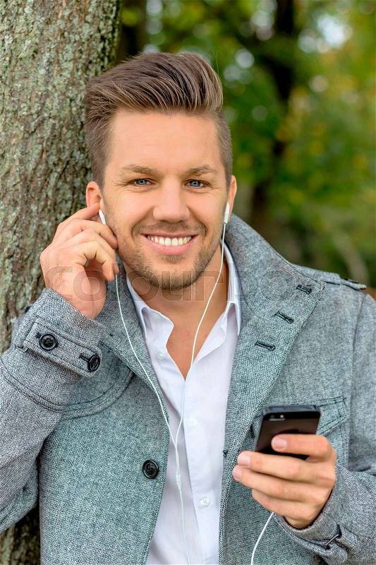 A man listens to music with your phone. talking on the mobile phone, stock photo