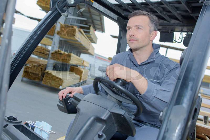 Man driving a forklift, stock photo