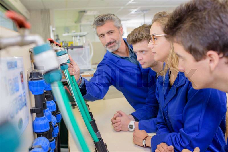 Craft teacher with students, stock photo