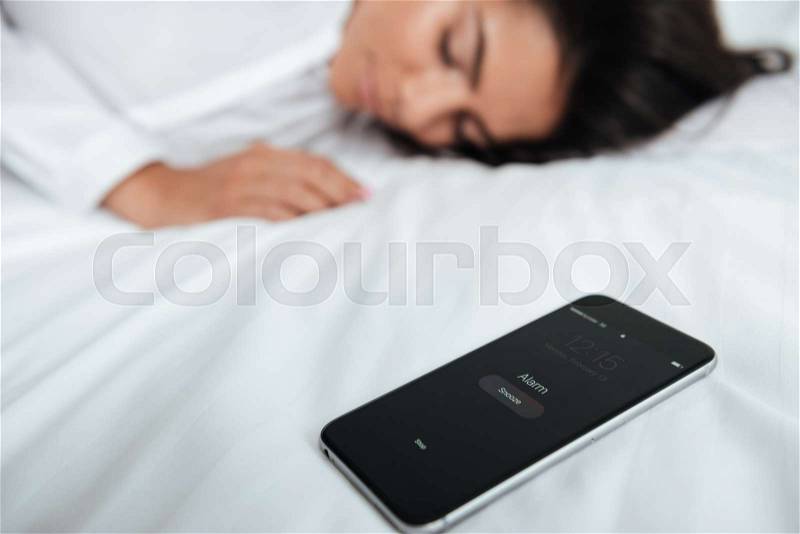 Tired businesswoman laying in bed overslept her meeting in the office, stock photo